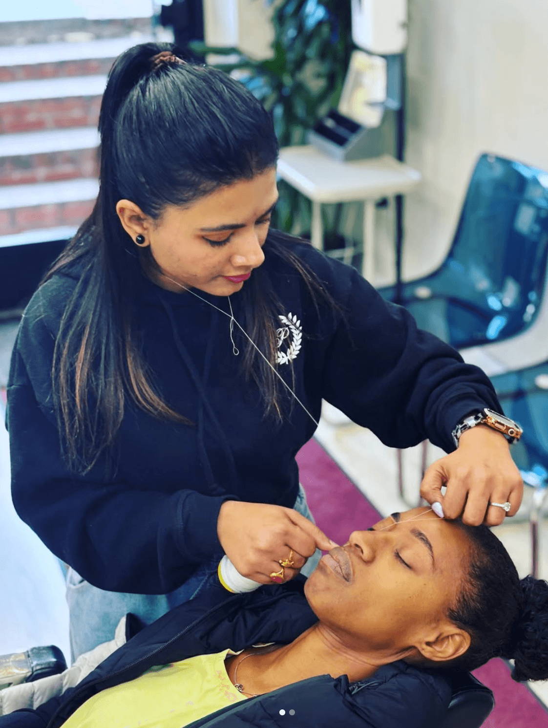 Angel threading a client's brows at Angels Brows Shaping